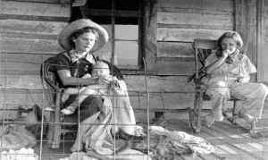 Myrtle Lawrence holds her grandson Ray Kimbrell while her sixteen-year-old daughter-in-law, Sylvia Lawrence laughs as she looks on.